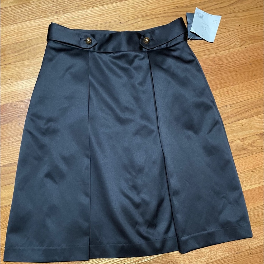 Dressy skirt with two pleats and gold buttons. Satin like matte fabric. Size 10